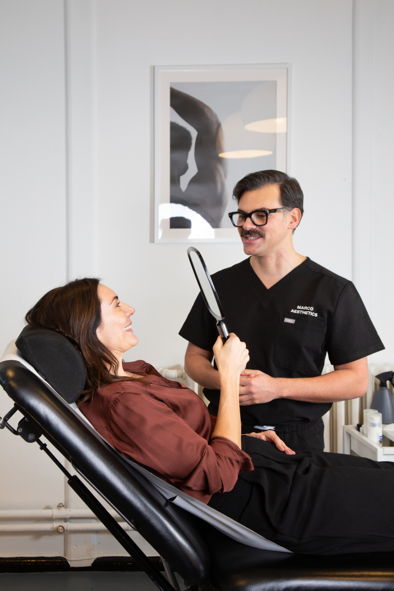 Marco discusses the results of botox treatment with a client in his Shoreditch, London studio